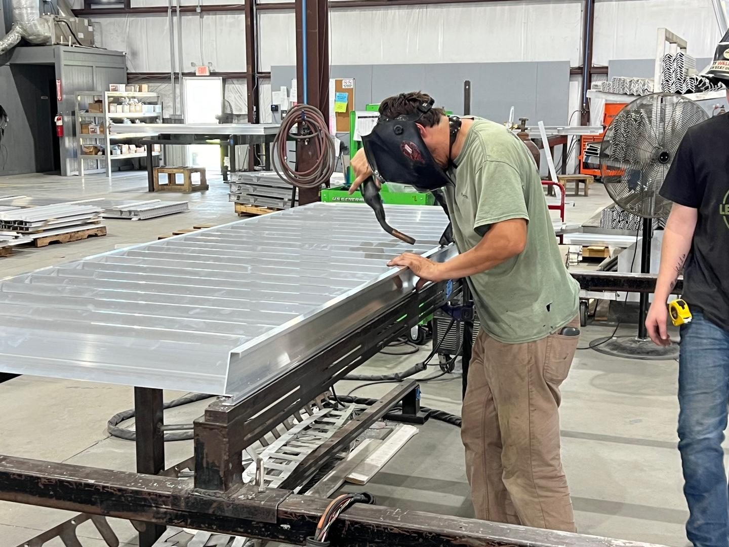 Welding along the edge of a louver frame
