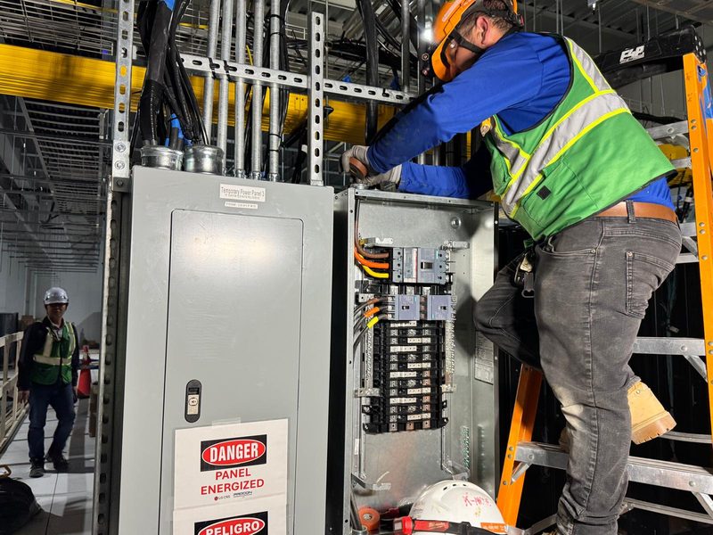 Electrician terminating a panelboard