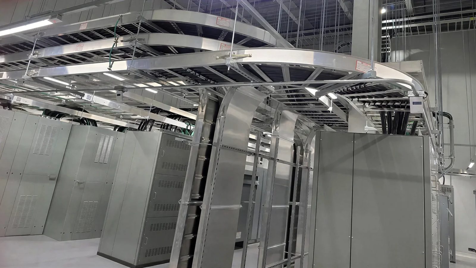 Aluminum ladder tray dropping into switchgear and UPS cabinets in a battery plant data center