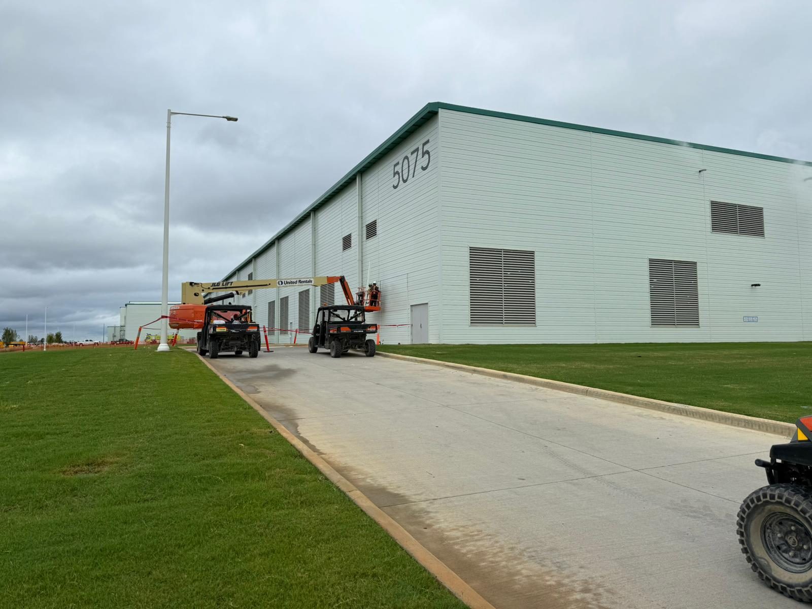 Wall louvers on the plant exterior, with a crew working from an aerial lift