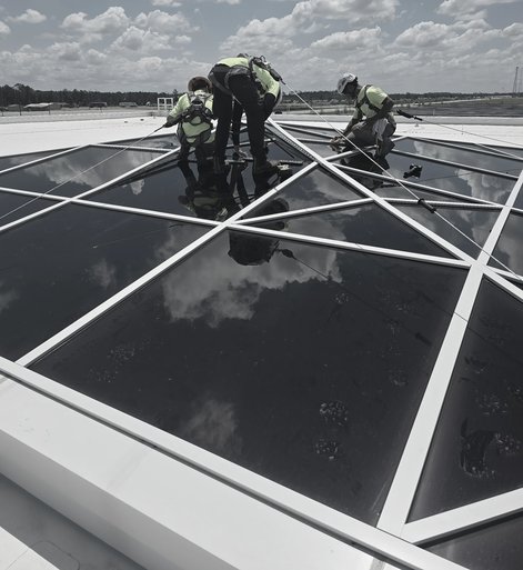 Crew setting skylights on a space-frame roof